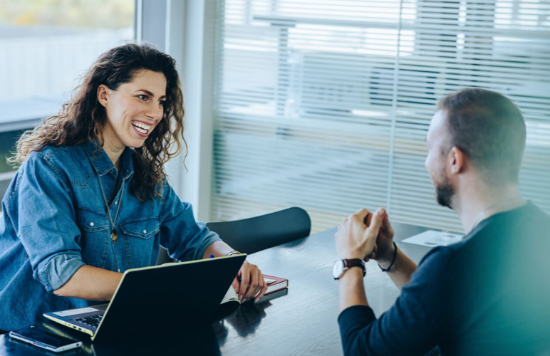 Executive Assistants collaborating with laptops and AI tools